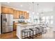 Modern kitchen with granite countertops, stainless steel appliances, and breakfast bar at 19377 E Radcliff Pl, Aurora, CO 80015