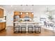 Bright kitchen featuring stainless steel appliances, a breakfast bar, and natural wood cabinets at 19377 E Radcliff Pl, Aurora, CO 80015