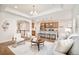 Open concept living space with modern furnishings and seamless flow to the kitchen at 19377 E Radcliff Pl, Aurora, CO 80015