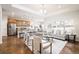 Bright and airy living room with open floor plan to kitchen and dining area at 19377 E Radcliff Pl, Aurora, CO 80015