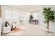 Inviting living room with neutral tones, large windows, stylish decor, and a comfortable seating area at 19377 E Radcliff Pl, Aurora, CO 80015