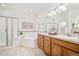 Bright main bathroom featuring a double vanity, a soaking tub, and a separate shower at 19377 E Radcliff Pl, Aurora, CO 80015
