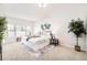 Serene main bedroom with a vaulted ceiling, large bed, decorative art, and a cozy sitting area by the window at 19377 E Radcliff Pl, Aurora, CO 80015