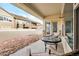 Covered patio area with seating, rock landscaping, and privacy fence offers a cozy outdoor retreat at 19377 E Radcliff Pl, Aurora, CO 80015
