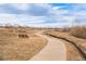 Scenic walking path with a bench, perfect for enjoying nature and outdoor recreation at 19377 E Radcliff Pl, Aurora, CO 80015