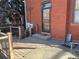 Brick home back door leads to wood deck, and is a cozy outdoor seating area at 1625 N Downing St, Denver, CO 80218