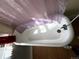 Simple bathtub with shower, clean white finish, natural light and modern fixtures at 1625 N Downing St, Denver, CO 80218