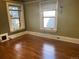 Bright bedroom featuring two large windows, offering ample natural light and hardwood flooring at 1625 N Downing St, Denver, CO 80218