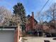 Charming brick home with a covered deck and stairway, perfect for enjoying the outdoors at 1625 N Downing St, Denver, CO 80218