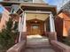 Inviting front porch showcases detailed columns and provides a warm welcome to the home at 1625 N Downing St, Denver, CO 80218