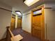 Hallway featuring multiple wood doors and trim, carpeted floor and neutral wall colors at 1625 N Downing St, Denver, CO 80218