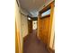 Hallway with multiple wood doors and trim, carpeted floor and neutral wall colors at 1625 N Downing St, Denver, CO 80218