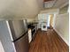 Efficient kitchen featuring stainless steel appliances, wood cabinets, and an adjacent in-unit laundry area at 1625 N Downing St, Denver, CO 80218