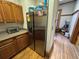Bright kitchen with a stainless steel refrigerator, wooden cabinets, and hardwood flooring at 1625 N Downing St, Denver, CO 80218