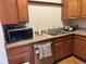 Kitchen with wooden cabinets, stainless steel appliances, and laminate countertops at 1625 N Downing St, Denver, CO 80218