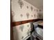 Storage area featuring custom wallpaper, coat hooks, and plastic storage bins at 1625 N Downing St, Denver, CO 80218
