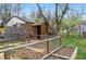 Backyard area featuring a wooden shed, garden space, wooden fence, and mature trees providing shade at 3278 S Lafayette St, Englewood, CO 80113