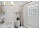 Bright bathroom with a tub and shower, tile surround, and modern fixtures at 3278 S Lafayette St, Englewood, CO 80113