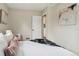 Cozy bedroom with view to the doorway, neutral walls, and white bedding with a throw at 3278 S Lafayette St, Englewood, CO 80113