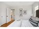 Bedroom boasting hardwood floors, neutral walls, with white linens and view to doorway at 3278 S Lafayette St, Englewood, CO 80113