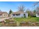 Charming single story home featuring a lovely front yard with a stone walkway and purple window shutters at 3278 S Lafayette St, Englewood, CO 80113