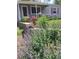 Inviting front yard with vibrant perennials, potted flowers and purple shutters at 3278 S Lafayette St, Englewood, CO 80113
