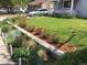 Landscaped front yard features colorful roses, lush greenery, and healthy lawn in front of light blue house at 3278 S Lafayette St, Englewood, CO 80113