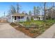 Charming home showcasing a landscaped front yard, complemented by purple shutters and a quaint yellow bench at 3278 S Lafayette St, Englewood, CO 80113