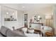 Stylish living room with a view into the kitchen, showcasing modern furniture and decor with hardwood floors at 3278 S Lafayette St, Englewood, CO 80113