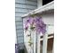 Close-up of purple clematis flowers on the porch, adding a touch of elegance to the home's entrance at 3278 S Lafayette St, Englewood, CO 80113