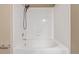 Clean white tiled bathtub with shower head in bathroom at 8427 S Hoyt Way # 107, Littleton, CO 80128