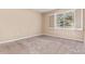 Cozy bedroom with neutral carpet and a bright window with shutters at 8427 S Hoyt Way # 107, Littleton, CO 80128