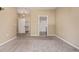 Neutral bedroom with carpet and closet access with connected bathroom at 8427 S Hoyt Way # 107, Littleton, CO 80128