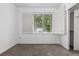 Inviting bedroom featuring neutral carpet, white walls and a bright window with shutters at 8427 S Hoyt Way # 107, Littleton, CO 80128