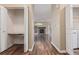 Hallway with wood floors, large closets, and view of living room with fireplace at 8427 S Hoyt Way # 107, Littleton, CO 80128