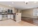 Bright kitchen with stainless steel appliances and half-wall overlooking living area at 8427 S Hoyt Way # 107, Littleton, CO 80128