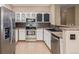 Well-lit kitchen with stainless steel appliances and brown backsplash at 8427 S Hoyt Way # 107, Littleton, CO 80128