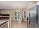 Spacious kitchen and dining area with tile flooring and stainless steel refrigerator at 8427 S Hoyt Way # 107, Littleton, CO 80128