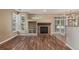 Inviting living room with hardwood floors, fireplace, and plantation shutters at 8427 S Hoyt Way # 107, Littleton, CO 80128