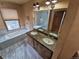 Rustic primary bathroom with double vanity, soaking tub, and shower at 902 S Potomac Way, Aurora, CO 80012