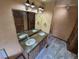 Rustic bathroom featuring double sink vanity with large mirror and lighting at 902 S Potomac Way, Aurora, CO 80012