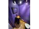 Unique powder room with purple walls, custom sink, and modern fixtures at 902 S Potomac Way, Aurora, CO 80012