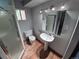 Cozy bathroom featuring a stand-alone sink, toilet, and a separate shower at 902 S Potomac Way, Aurora, CO 80012