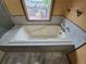 Close up of a bathtub with jets next to a window with outside view at 902 S Potomac Way, Aurora, CO 80012