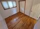 Cozy bedroom featuring hardwood floors, a window, and closet space at 902 S Potomac Way, Aurora, CO 80012