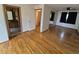 Bright bedroom with hardwood floors leading to a bathroom with wood cabinets at 902 S Potomac Way, Aurora, CO 80012