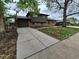 Charming two-story home with a brick and wood facade, a spacious driveway and a partially landscaped front yard at 902 S Potomac Way, Aurora, CO 80012