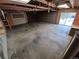 Spacious garage with overhead door and sliding glass door to the exterior at 902 S Potomac Way, Aurora, CO 80012