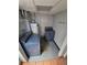 Functional laundry room with modern washer, dryer and overhead shelving at 902 S Potomac Way, Aurora, CO 80012
