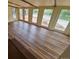Bright and airy living room with hardwood floors and multiple doors at 902 S Potomac Way, Aurora, CO 80012